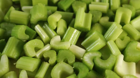 A bunch of slices of chopped fresh celery rotate. 