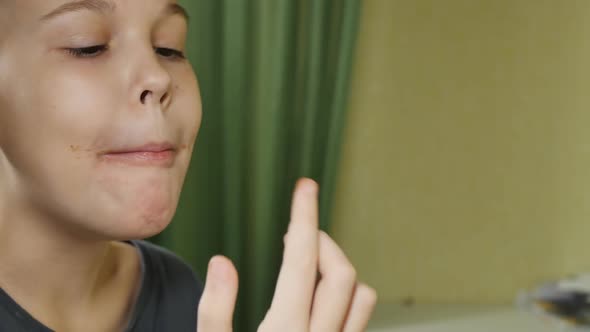 Beautiful Teen Girl Licks Chocolate on Her Fingers After a Delicious Sandwich