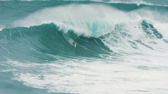 Surfer in Caught Giant Wave in Atlantic Ocean, Instructor Accompanies Nearby on Jet Ski