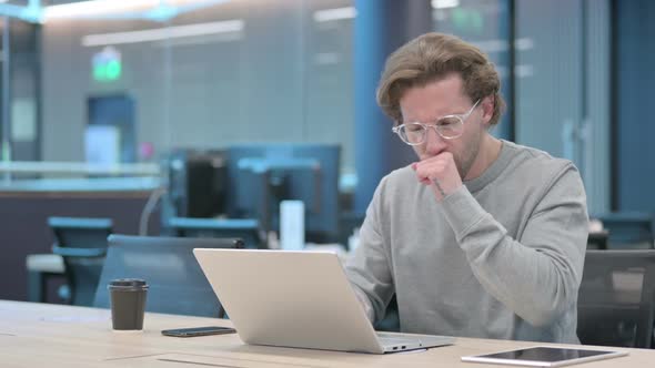 Young Businessman with Laptop Having Coughing