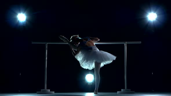 Ballerina in White Tutu Doing a Workout in the Classroom Near Barre