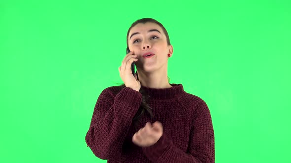 Portrait of Smiling Girl Talking for Mobile Phone and Rejoice, Green Screen