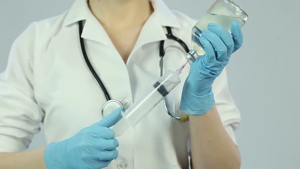 Veterinary Physician With Huge Syringe Preparing Injection for Sick Animal