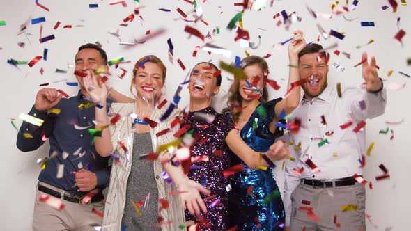 Happy Friends at Party Under Confetti Over White