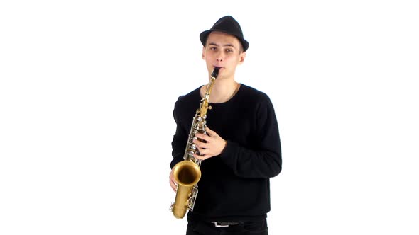 Talented Saxophonist Performs Solo on Saxophone. White Background in Studio