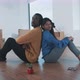 Young multi ethnic couple sitting on the floor of their new home - VideoHive Item for Sale