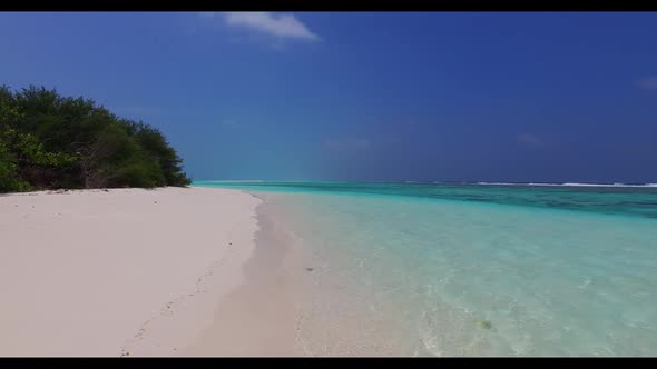 Aerial drone shot seascape of beautiful tourist beach holiday by blue lagoon with white sandy backgr