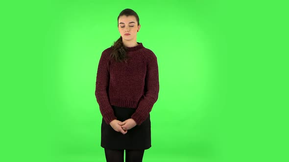 Girl Listens Carefully To Boring Information and Looks Around. Green Screen