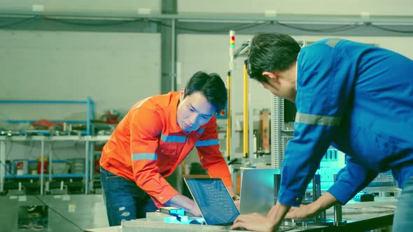 two asian coworker brainstorm  explaining and solves the process of the cnc operate machine