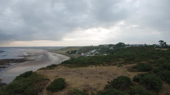 Women holding child on Beauport Beach.