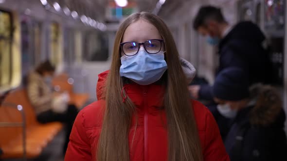 Blonde Teen Girl in Face Mask Riding in Metro Car