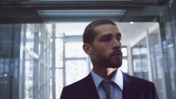 Businessman getting out of elevator at modern office 4k