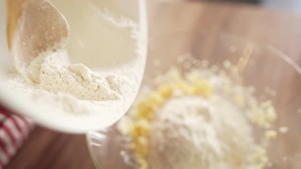 Woman Baker Sifting Flour for Dough Through Bolter