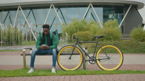 young african man works as a food delivery man.