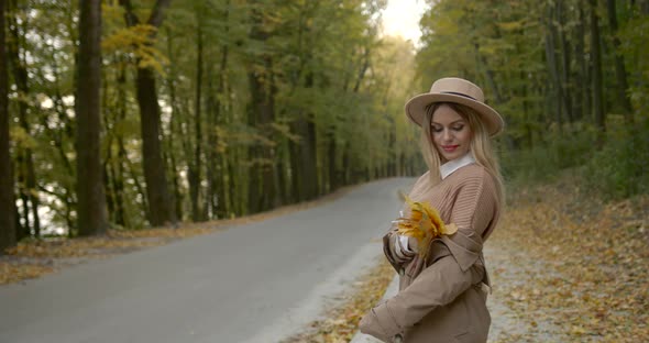 Young Stylish Woman in a Hat and Beige Coat