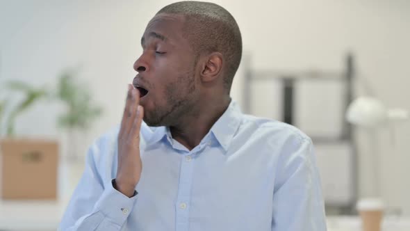 Portrait of Tired African Man Yawning in Office