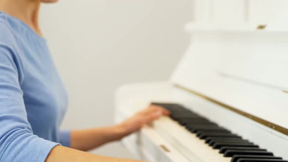 Woman playing piano at home 4k