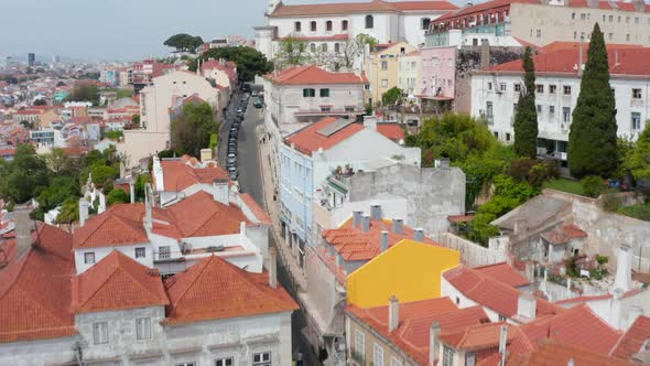 Flying Drone Camera Above Narrow Street Leading Uphill to Large Sacral Building Grace Church and