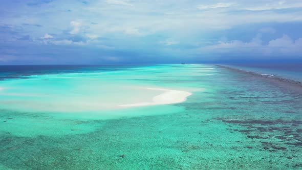 Wide overhead tourism shot of a sunshine white sandy paradise beach and turquoise sea background in 