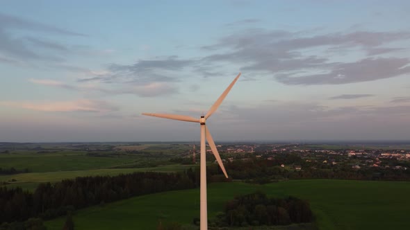 Aerial View Of The moving windmill turbine on countryside background.