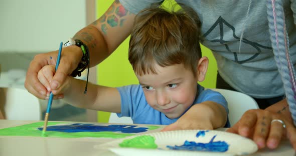 Happy Cute Children a Girl of 78 Years Old and Preschool Boy Paint at Home with Watercolors Sitting