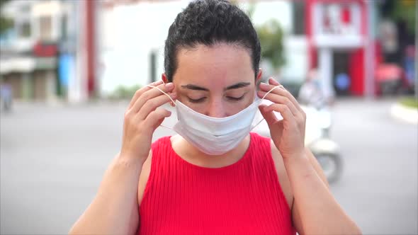 Portrait of a Young Student Mixed Race Woman Wearing Protective Mask on Street. Concept of Health
