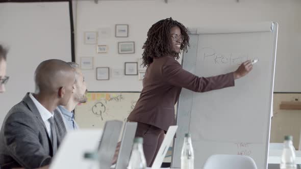Smiling African American Woman Standing Near Whiteboard