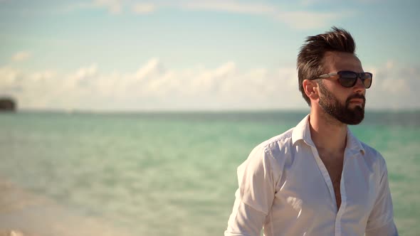 Businessman Enjoying Tropical  Resort Hotel Vacation. Handsome Man Walking On Tropical Beach.