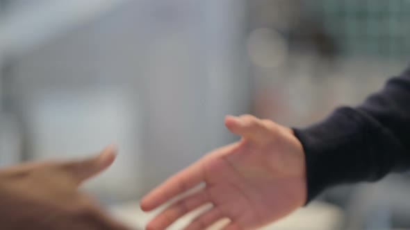 African Man and Caucasian Man Shaking Hands Close Up