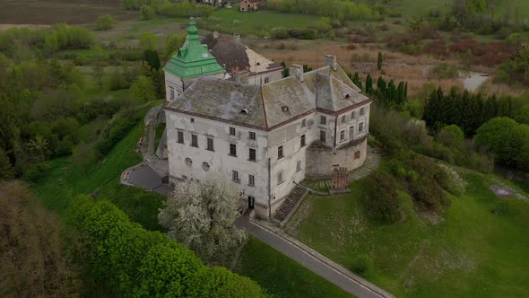 Aerial View of Olesky Castle and the Surrounding Landscape in Spring, Ukraine