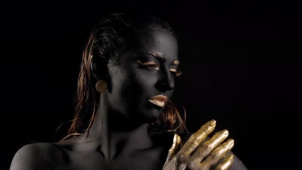 Portrait of a Young Woman with Magical Black Skin and Golden Hands