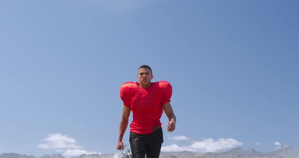 American football player walking with helmet