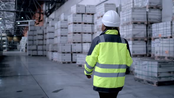 Follow Footage of Employees Famale Warehouse Worker Engineer in Hard Hat Working
