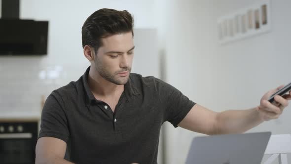 Cheerful Man Holding Smartphone for Picture at Living Room