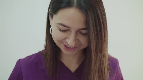 Portrait of Happy Beautician in Uniform Smiling During Treatment