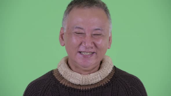 Face of Happy Mature Japanese Man Smiling and Laughing Ready for Winter