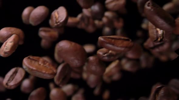 Super Closeup of Roasted Coffee Beans Rotating on the Black Background