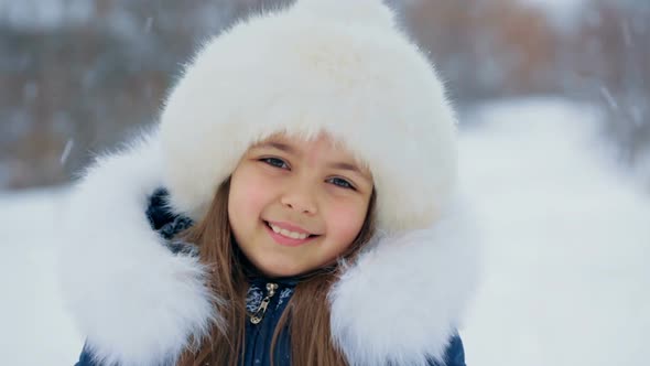 Girl in White Furry Hat on a Winter Day