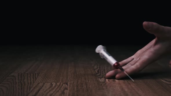 Overdose Addict's Hand Falls to the Floor Drug Syringe Falls Out of It