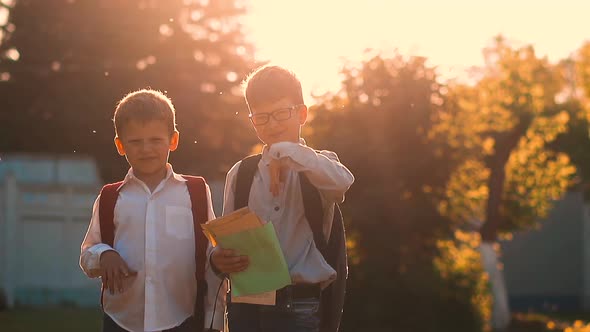 Kids in School Uniform with Bags Stand Holding Books