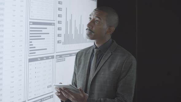 Confident Black Finance Expert Analyzing Trading Charts