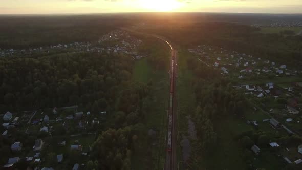 Flying Over Countryside and Freight Train at Sunset, Russia