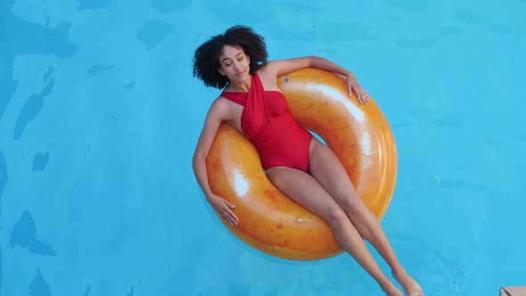 Tanned Curly Teenage Girl in Fashionable Swimsuit Relaxing in Pool After School on Vacation at Home