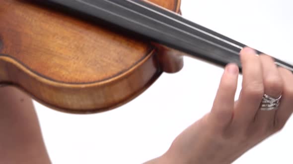 Violin in Female Hands, Getting Played By the Woman at White Background. Close Up.