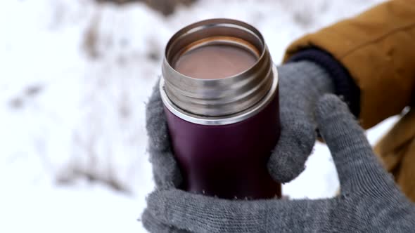 Unrecognizable Person Holding Small Thermos with Hot Chocolate