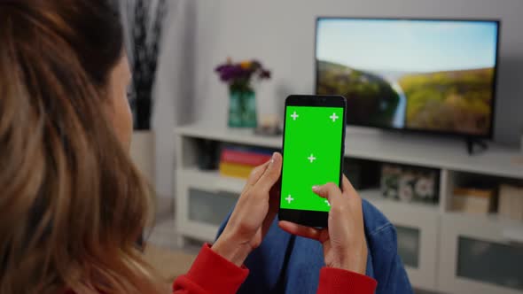 Woman Using Smartphone with Green Screen for Copy Space Close