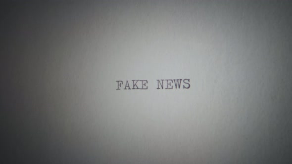 Fake news printed with a typewriter on a piece of paper, captured on a shaking camera.