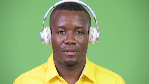 Young Happy African Businessman Listening To Music