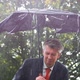 Businessman Sheltering Underneath a Broken Umbrella in the Rain - VideoHive Item for Sale