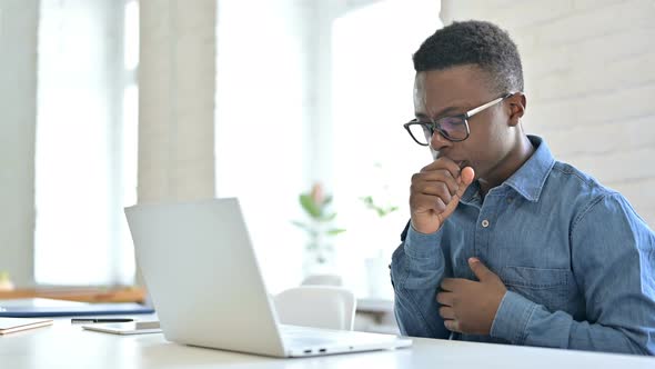 Allergic Young African Man with Laptop Coughing at Work 